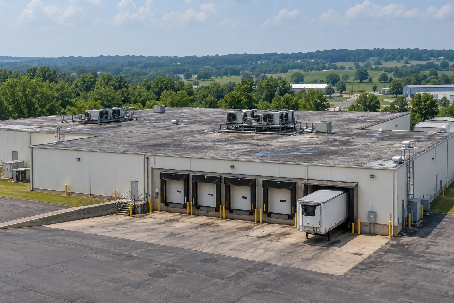 Warehouse roof with rooftop units above loading dock doors